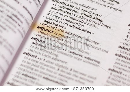 The Word Or Phrase Adjunct In A Dictionary Highlighted With Marker.