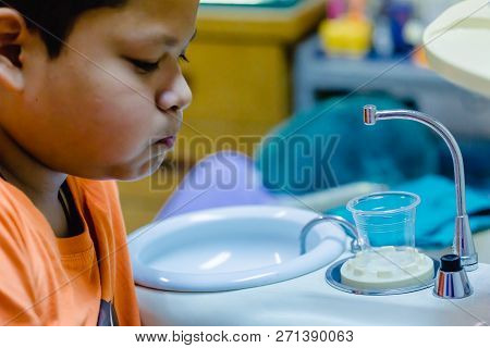 Boy Rinse One's Mouth After Dentist Common Operation Of Cleaning Boy Mouth.