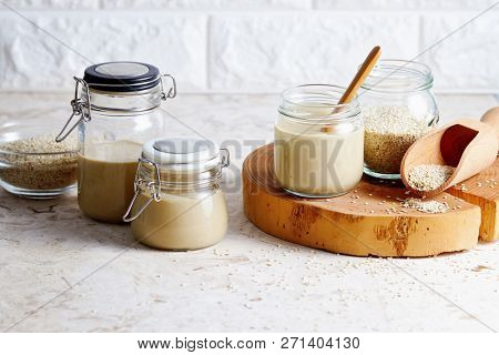 Homemade tahini in glass jars (sesame seed paste).