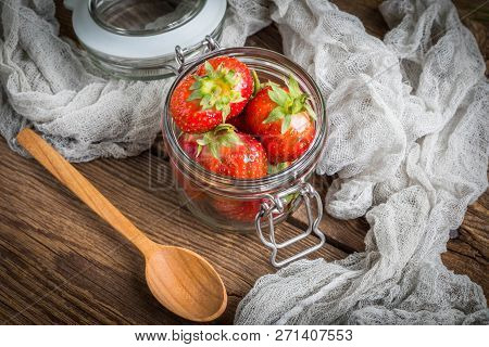 Strawberry In Jar On Wooden Background.