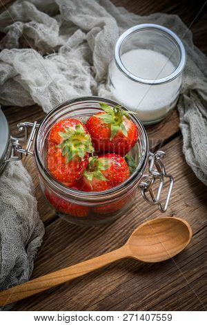 Strawberry In Jar On Wooden Background.