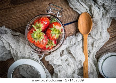 Strawberry In Jar On Wooden Background.