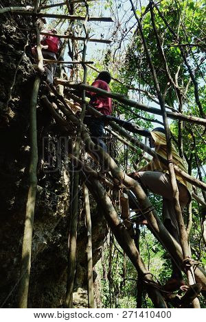 Lolits Village, Espiritu Santo Island / Vanuatu - Aug 10 2016 : Villagers Climbing A Large Rock Ston