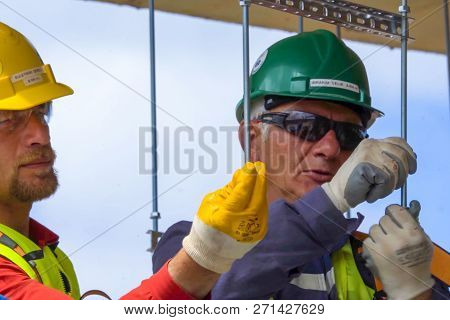 Moscow, Russia - May 22, 2018: Workers In Helmets On The Construction Site. Construction Works