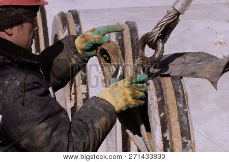 Irkutsk, Russia - March 24, 2017: Slinger At Work. Stroply Cargo. Worker In A Helmet.