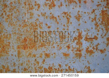 Rusted Metalic Background With Peeled Off Paint, Scrathes And Stains.