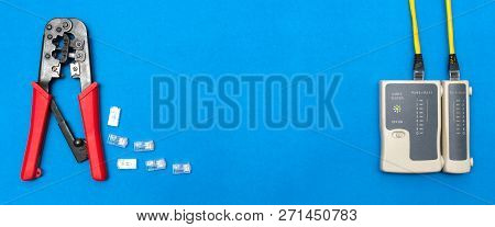 Cripmer Tool And Network Cable Tester Isolated On The Blue Background. Network Maitenance Background