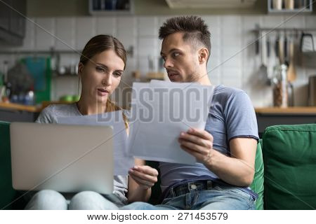 Upset Man And Woman Using Laptop, Check Documents