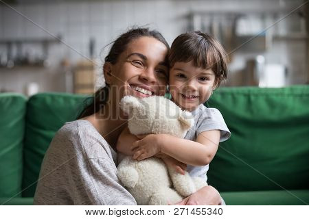 Smiling Single Young Mum Embracing Little Daughter