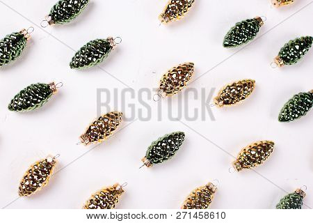 Christmas Or New Year Composition. Decorative  From Golden And Green  Pine Cones On Whitetextured Ba