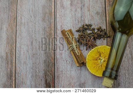 Hot Mulled Wine Drink With Lemon, Apple, Cinnamon, Anise And Other Spices In A Glass Cup Between Fir