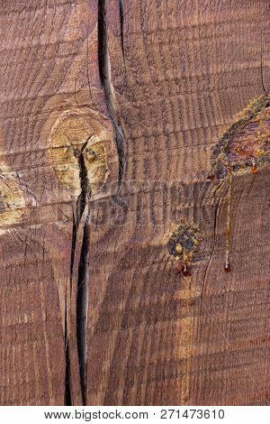 Wooden Pine Beam With A Crack Painted By Stain. Macro Texture Background. Spile Bitch With Drops Of 