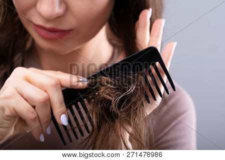 Close-up Of A Woman Combing Her Hair