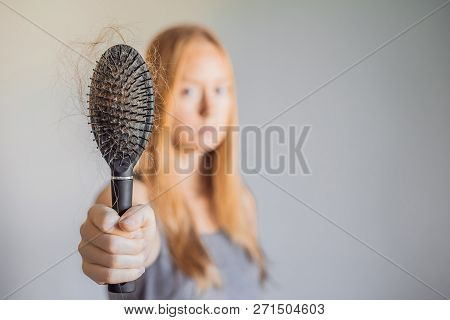 Hair Loss In Women Concept. A Lot Of Lost Hair On The Comb