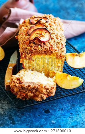 Homemade Apple Crumble Cake Served On A Wire Rack On A White Sto