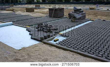 Heap Of Interlocking Paving Stones; Material For Paving Works On Sheet Of Nonwoven
