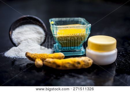 Close Up Of Face Pack Of Rice Flour With Fresh Face Cream And Turmeric Powder On Wooden Surface In A