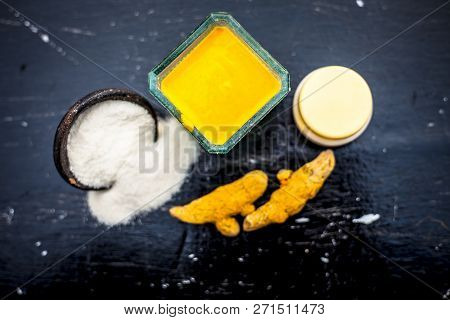 Close Up Of Face Pack Of Rice Flour With Fresh Face Cream And Turmeric Powder On Wooden Surface In A