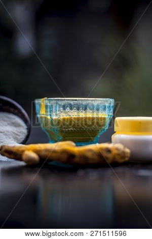 Close Up Of Face Pack Of Rice Flour With Fresh Face Cream And Turmeric Powder On Wooden Surface In A