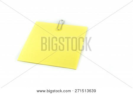 paper clip pin on white / yellow stick note paper with clip isolated on white background