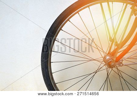 vintage bicycle wheel / close up of details bicycle wheel spokes on wall background - bike front wheel