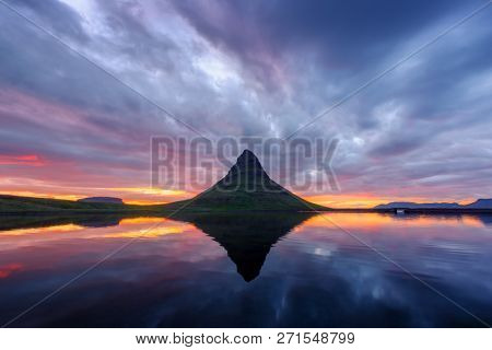 Colorful sunrise on Kirkjufellsfoss waterfall. Amazing morning scene near Kirkjufell volkano, Iceland, Europe. Landscape photography