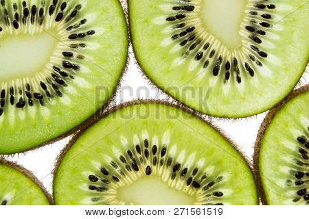Sliced Kiwifruit Rings On White Background Top View Macro