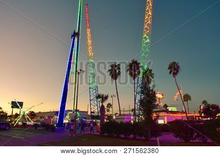 Orlando, Florida. November 12, 2018 Colorful Attractions And Palms Trees On Beatiful Sunset Backgrou