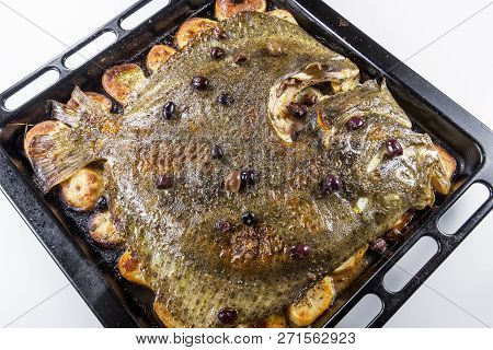 Cooked Whole Turbot Fish In Baking Pan Oven With Potatoes Olives And Aromatic Herbs Isolated On Whit