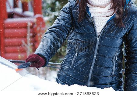 Man Cleaning Snow From Car Windshield With Brush, Close Up. Woman Removing Snow From Car. Snowy Wint