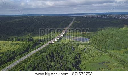 Top View Of Bridge Passing Through In Forest. Clip. Highway Passes Through Swamp In Forest To City O