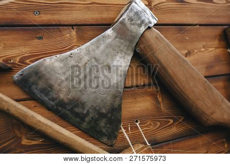 Vintage Ax Narrow Blade Vertical Wooden Panel Close-up On Wooden Background.