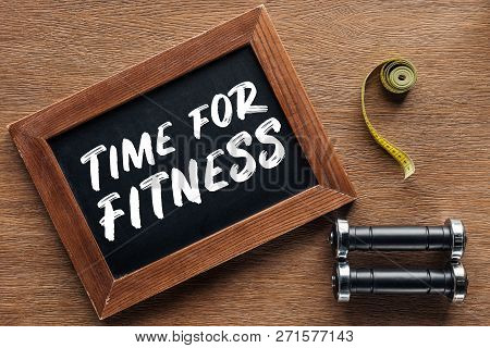 Measuring Tape, Dumbbells And Wooden Chalk Board With Time For Fitness Quote, Dieting And Healthy Li
