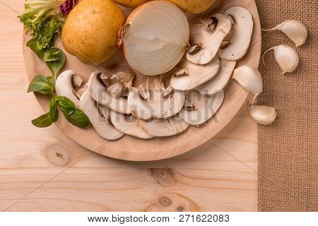 Appetizing Products For Cooking, Mushrooms, Potatoes, Onions, Garlic, Herbs On A Wooden Background W