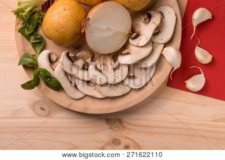 Appetizing Products For Cooking, Mushrooms, Potatoes, Onions, Garlic, Herbs On A Wooden Background W