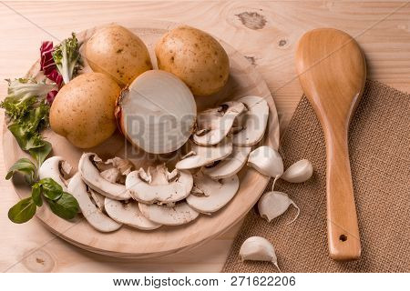 Appetizing Products For Cooking, Mushrooms, Potatoes, Onions, Garlic, Herbs On A Wooden Background W