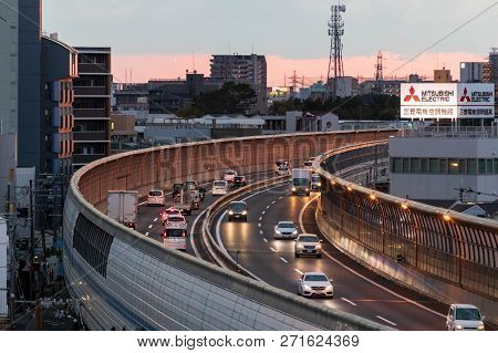 Osaka, Japan - November 10, 2018: Traffic On Hanshin Expressway Curves By Billboard For Mitsubishi E