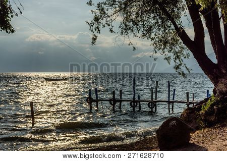 Passenger Boat Cruises In Late Afternoon Light On Lake Atitlan In Guatemalan Highlands