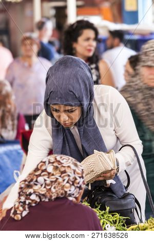 Turkish Woman Is Paying For The Food That She Just Bought At Bazaar - Seferihisar, Izmir, Turkey, 12