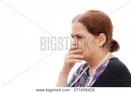 Portrait Of A Turkish Middle-age Woman With Worried Face Expression, Isolated Against A White Wall -
