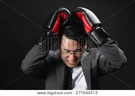 Asian Business Man In Suit And Boxing Gloves, Express His High Stressful And Unhappy, Losing In Comp
