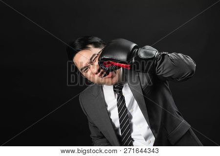 Asian Business Man In Suit And Boxing Gloves, Punch The Face By Himself, Express His Hurt Feeling On
