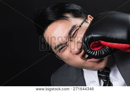 Asian Business Man In Suit And Boxing Gloves, Punch The Face By Himself, Express His Hurt Feeling On