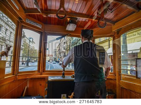 Prague, Czechia - Oct 27, 2018. The Tram Driver In Cockpit Of Vintage Wooden Tram Shown On A Street 
