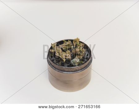 Steel Grinder With Green Cannabis Flower (buds) Inside.