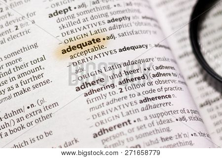 The Word Or Phrase Adequate In A Dictionary Highlighted With Marker.