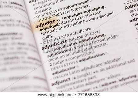 The Word Or Phrase Adjudge In A Dictionary Highlighted With Marker.