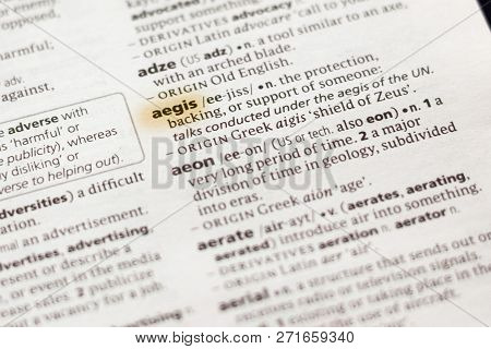The Word Or Phrase Aegis In A Dictionary Highlighted With Marker.