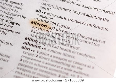The Word Or Phrase Aileron In A Dictionary Highlighted With Marker.