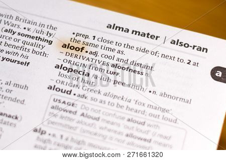 The Word Or Phrase Aloof In A Dictionary Highlighted With Marker.